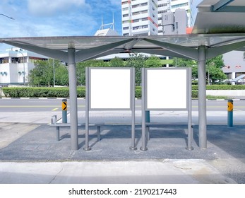 Two Bus Stop Blank Advertising Mock Ups At Empty Bus Stop Shelter By Main Road. Out-of-home OOH Classifieds Billboard Advertisement Media In The City