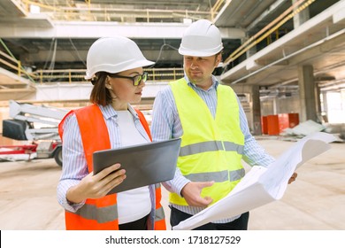 Two business builder people at construction site. Builder, inspector, engineer, architect, customer, people working at building