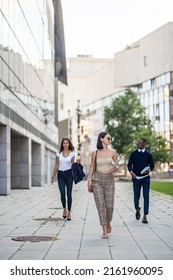 Two Business Co Workers Are Walking Behind Their Attractive And Beautiful Female Boss