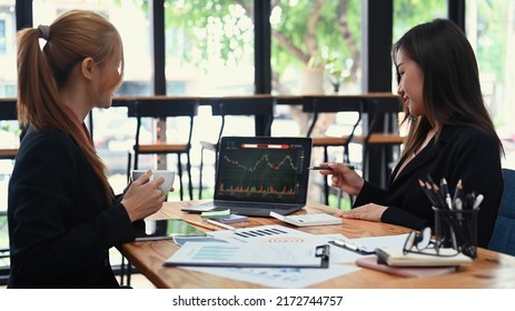 Two Business Colleagues In Formal Wear Analyzing Stock Charts On Laptop Screen, Working Together To Trading Strategy At Corporate Finance Fund