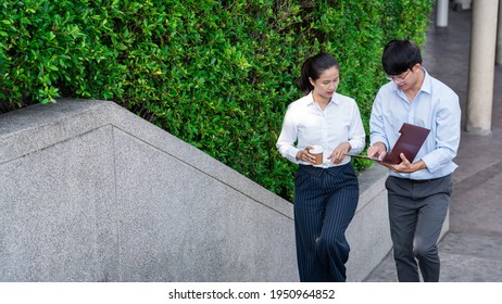 Two Business Colleagues Having Discussion New Project Business Meeting Outside Office In An Urban Setting. 