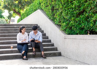 Two Business Colleagues Having Discussion New Project Business Meeting Outside Office In An Urban Setting. 