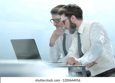 Two Business Colleagues Looking At The Laptop Screen