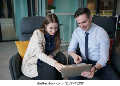 Two Business Colleagues At Meeting In Modern Office Interior, Young Man Consulting His Business Partner At Meeting In Office