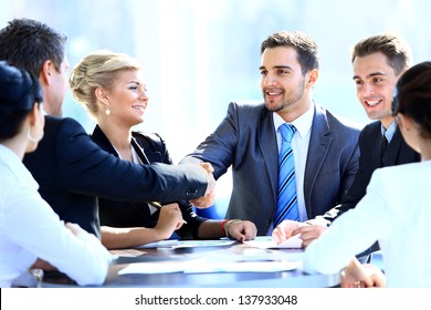 Two Business Colleagues Shaking Hands During Meeting