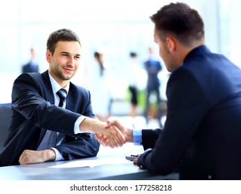 Two Business Colleagues Shaking Hands During Meeting