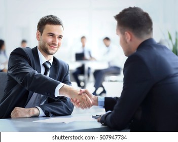 Two Business Colleagues Shaking Hands During Meeting