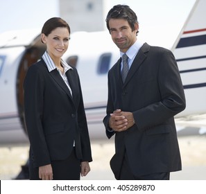 Two Business Colleagues Standing By A Plane