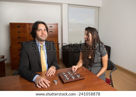 Two business executives playing at the office, she won