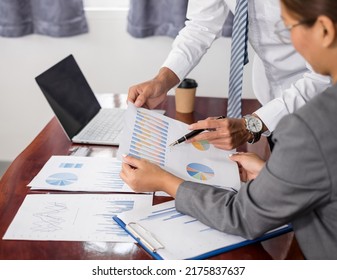 Two business leaders talk about charts, financial graphs showing results are analyzing and calculating planning strategies, business success building processes. - Shutterstock ID 2175837637