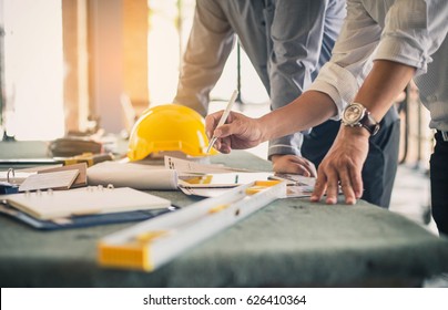Two business man construction site engineer  Engineering objects workplace and partners interacting background