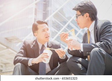 Two Business Man Eating Noodles