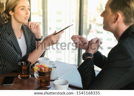 Two business man and woman couple meeting in co working space at skyscraper lounge