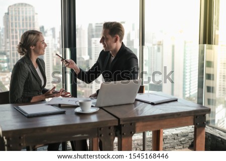 Two business man and woman couple meeting in co working space at sky lounge