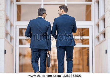 Two business men brainstormed ideas for their next business. Business men analyzed the market trends before making their decision. Business successful. Businessmen were motivated to succeed.