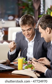 Two business men have dinner at restaurant