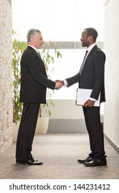 Two Business Men Shaking Hands In Office