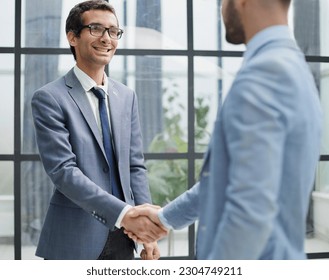 Two business men shaking hands together after successful meeting. - Shutterstock ID 2304749211
