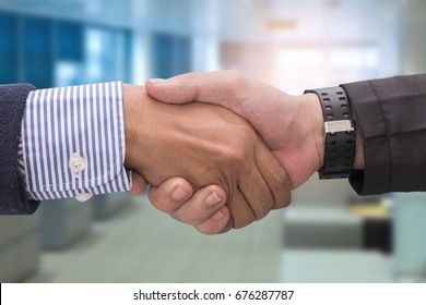 Two Business Men Shaking Hands In Office,close Up