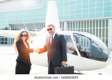 Two Business Men And Woman Shaking Hand To Appreciate Each Other About Aviation Business And Helicopter Platform Background, Close Up People Hands Shake Business Partnership Successful Outdoors, Deal 