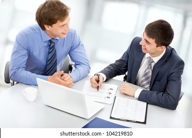 Two Business Men Working On A Laptop