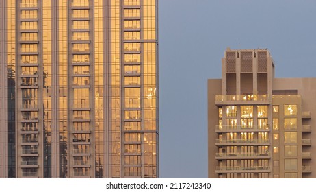 Two Business Office Skyscrapers At Sunset With Stunning Sun Reflections On The Teal And Orange Glass Facades, With Blue Sky Timelapse