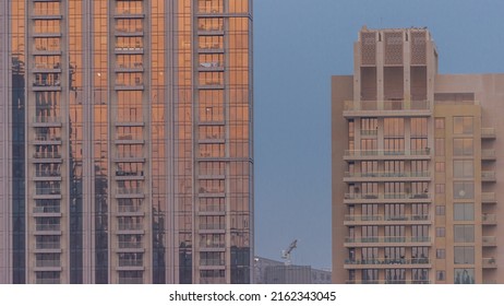 Two Business Office Skyscrapers At Sunset With Stunning Sun Reflections On The Teal And Orange Glass Facades, With Blue Sky Timelapse