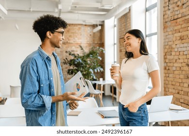 Two business partners colleagues college students classmates workers managers having discussion talking drinking coffee taking pause during work study break in office modern coworking cafe - Powered by Shutterstock