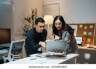 Two business partners looking concerned having a disagreement while working late night in the office - Powered by Shutterstock