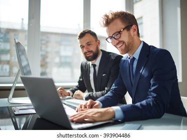 Two Business Partners Working With Laptop Together