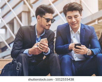 Two Business People Discuss Business Affair On Mobile Phone. Communication Technology And Business Concept.