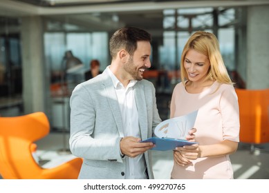 Two business people discussing about work in an office.