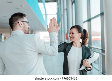  Two business people high-five. Job well done.