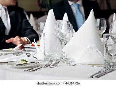 two business people no faces over a restaurant table