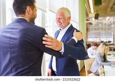 Two business people in the office greet each other as business partners or colleagues - Shutterstock ID 2115523622