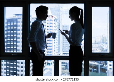 Two Business People In A Office Setting. 