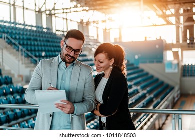 Two Business People Organizing An Event In Sport Hall.