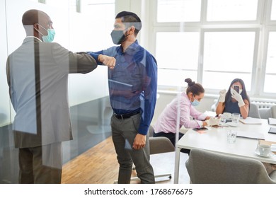 Two Business People Salute Each Other As Prevention Of Coronavirus Infection