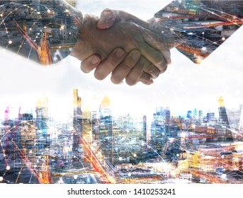 Two Business People Shaking Hands As Symbol Of Agreement, Consolidation, Business Development And Support. Multiple Exposure Image