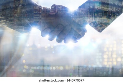 Two Business People Shaking Hands As Symbol Of Agreement, Consolidation, Business Development And Support. Multiple Exposure Image