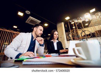 Two business people solving problem after work.