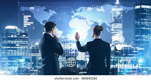 Two Business People Standing With Back And Working Together With Virtual Screen