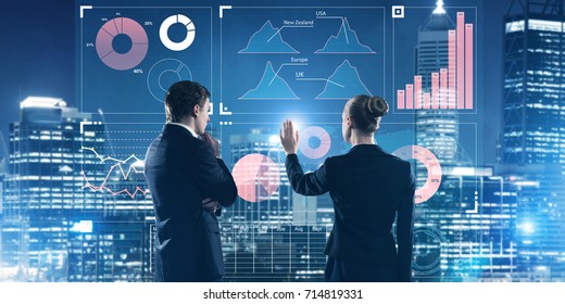 Two Business People Standing With Back And Working Together With Virtual Screen