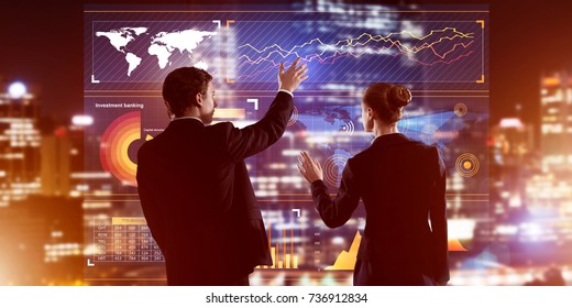 Two Business People Standing With Back And Working Together With Virtual Screen