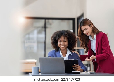 Two business people talk project strategy at office meeting room. Businessman discuss project planning with colleague at modern workplace while having conversation and advice on financial data report. - Shutterstock ID 2278459923