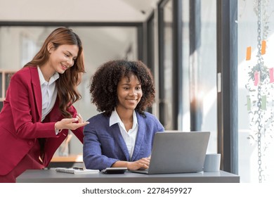 Two business people talk project strategy at office meeting room. Businessman discuss project planning with colleague at modern workplace while having conversation and advice on financial data report. - Shutterstock ID 2278459927
