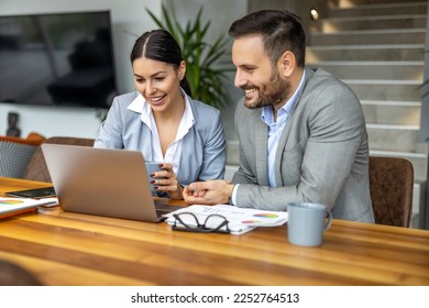 Two business people using laptop and discussing about new project at office,preparing presentation and having brainstorming session. - Shutterstock ID 2252764513