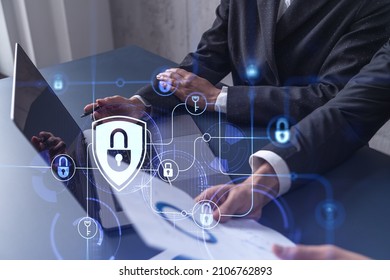 Two business people working on the project to protect cyber security of international company using laptop. Padlock Hologram icons. Teamwork concept. - Shutterstock ID 2106762893