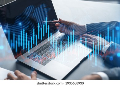 Two business people working together on stock market strategy. Try to analyze forex behavior. Financial graph hologram. Double exposure. - Shutterstock ID 1935688930