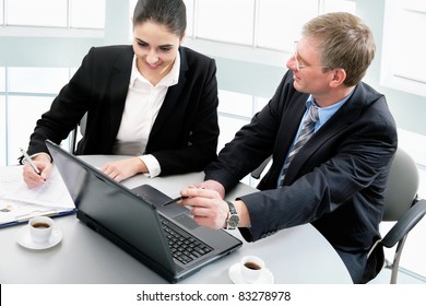 Two Business People Working Together At Office